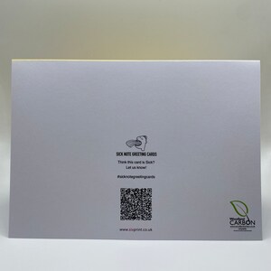 May include: A white greeting card with a black and white illustration of a person with a speech bubble saying "Sick Note Greeting Cards". The card has a black and white QR code and the text "Think this card is Sick? Let us know! #sicknotegreetingcards www.sixprint.co.uk" printed on it. The card also has a black and white logo for Woodland Carbon.