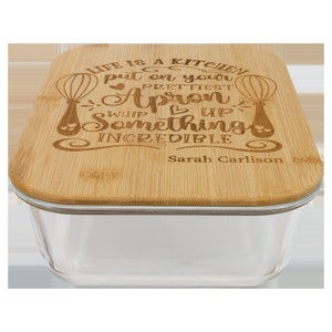 May include: A square glass container with a bamboo lid. The lid has a laser-engraved quote that reads "Life is a kitchen, put on your prettiest apron, whip up something incredible." The quote is signed "Sarah Carlson".
