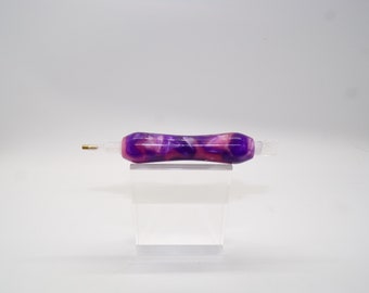 May include: A purple and pink marbled diamond painting pen with a gold tip.
