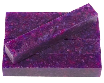 May include: A stack of five purple and pink resin pen blanks with a speckled pattern. The blanks are rectangular and have a smooth, polished finish.