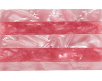 May include: A rectangular, pink and red decorative item with a marbled appearance. The item is divided into alternating bands of light pink and darker red, creating a striped effect. The material has a glossy finish.