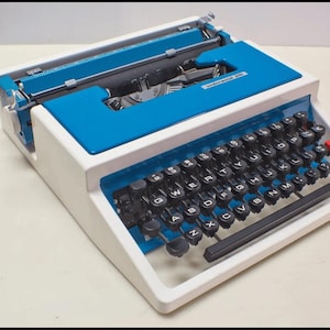 Vintage 1970s Olivetti Underwood 315 Portable Typewriter. Blue and white, perfect working condition! HIGHLY COLLECTIBLE!