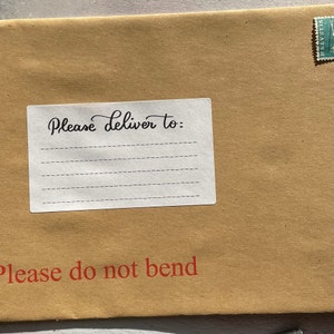 May include: A brown paper envelope with a white label that says "Please deliver to:" and has lines for writing an address. The envelope also has a red stamp that says "Please do not bend."