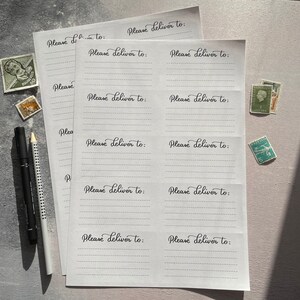 May include: A set of blank white cards with the text "Please deliver to:" printed on each card. The cards are arranged in a grid pattern and are ready for writing.