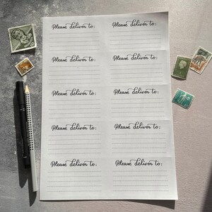 May include: A white sheet of paper with eight lines for writing addresses. Each line is labeled "Please deliver to:" in cursive handwriting.