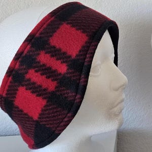 May include: Red and black plaid fleece ear warmer headband. The headband is made of soft, warm fleece and is designed to keep your ears warm in cold weather.
