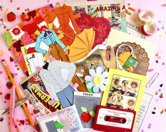 May include: A collection of vintage paper crafts, including paper dolls, a paper house, and a paper umbrella. There are also some paper doilies, a cassette tape, and a pencil. The items are arranged on a pink surface with confetti.