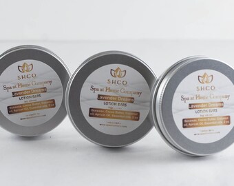 May include: Three silver tins with labels that read "SHCO Spa at Home Company Lavender Dreams Lotion Bars" with ingredients listed below.
