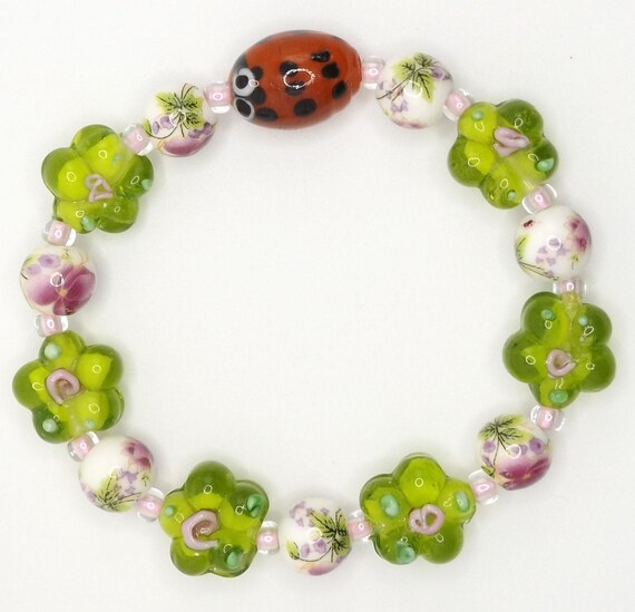 Stretch Bracelet with Ladybug Focal Bead _ Purple Porcelain Floral  _ Green Lampwork Flower Beads _ Handmade _ USA _ SPOCKLES