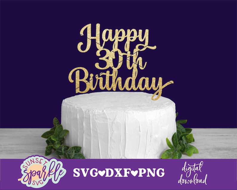 May include: Gold glitter cake topper with the text "Happy 30th Birthday" on a white frosted cake. The cake is decorated with green leaves.