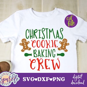 May include: White t-shirt with a green and red design that says "Christmas Cookie Baking Crew". Two gingerbread men are on either side of the text. The text "cut file" is in a purple box in the upper right corner. The text "SVG DXF PNG" is in a pink box at the bottom of the shirt. The text "digital download" is in a pink box in the lower right corner.