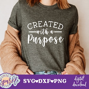May include: A gray t-shirt with the text "CREATED with a PURPOSE" in white lettering.
