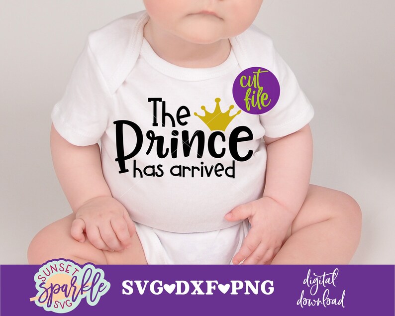 K&ouml;nnte beinhalten: Ein wei&szlig;er Strampler mit dem Text "The Prince has arrived" und einer goldenen Kronengrafik. Der Strampler wird von einem Baby getragen, das auf einer wei&szlig;en Oberfl&auml;che sitzt.