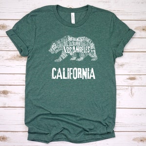 May include: A green t-shirt with a white outline of a bear made up of California city names. The text "CALIFORNIA" is below the bear.