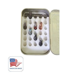 May include: A white plastic storage case with a metal lid. The case has 36 individual compartments for holding small items. The case is open and there are several small screwdriver bits inside.