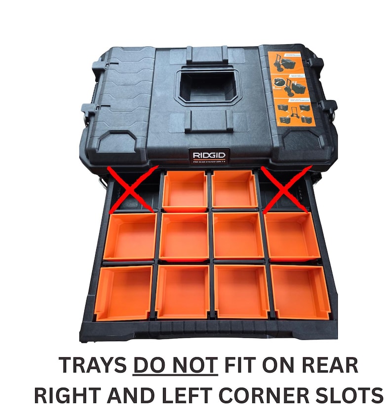 May include: Black RIDGID tool box with orange trays. The trays do not fit on the rear right and left corner slots. The tool box has a handle and latches for secure closure. The trays are orange and are designed for organizing tools.