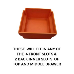 May include: An orange plastic storage bin with a rectangular shape and stepped sides. The text on the image reads: THESE WILL FIT IN ANY OF THE 4 FRONT SLOTS & 2 BACK INNER SLOTS OF TOP AND MIDDLE DRAWER.
