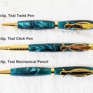 May include: Three teal and gold pens with a fish clip. The pens are a twist pen, a click pen, and a mechanical pencil.