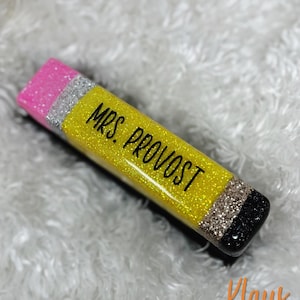 May include: A yellow pencil-shaped resin keychain with glitter, black and silver stripes, and a pink eraser. The keychain has the text "MRS. PROVOST" written on it.