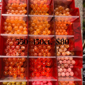 May include: A red plastic organizer filled with various sizes and colors of beads. The beads range in color from yellow to pink and orange. The text "350-450ct." is visible on the image.