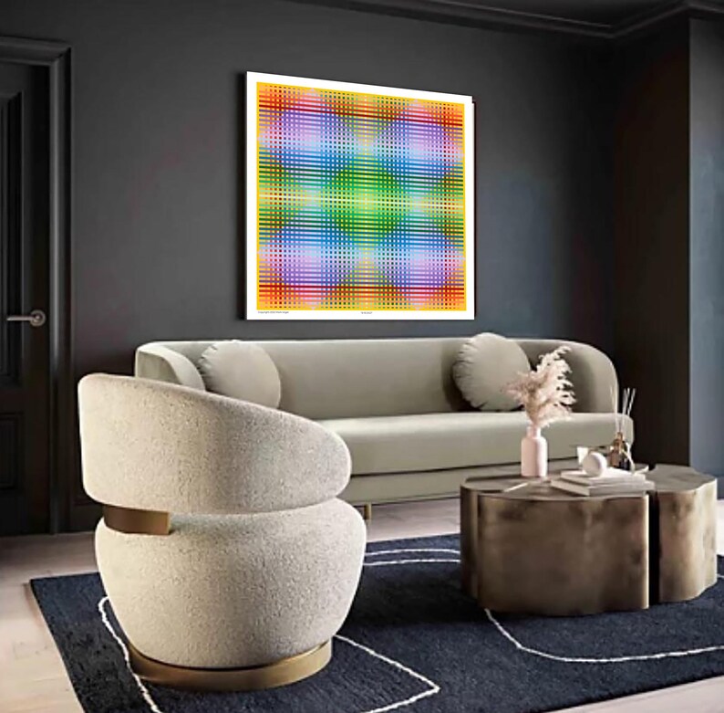 May include: A white, fluffy armchair with a gold metal base sits in a living room with a gray sofa, a coffee table, and a colorful abstract artwork on the wall.