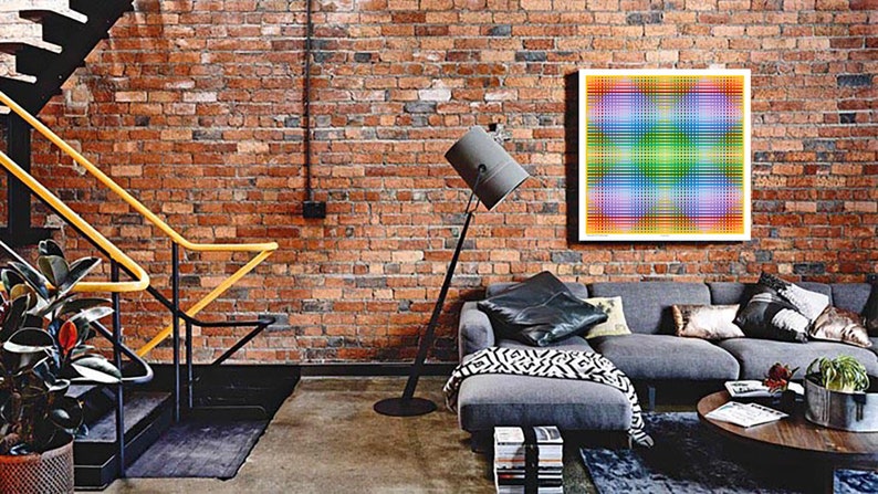May include: A living room with a brick wall, a gray sectional sofa, a floor lamp, and a colorful abstract artwork hanging on the wall.