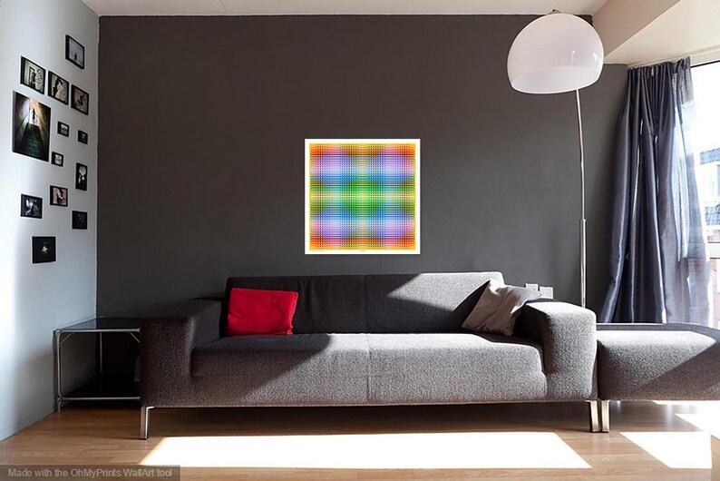 May include: A gray couch with red and gray throw pillows in a living room with a colorful abstract painting on the wall.