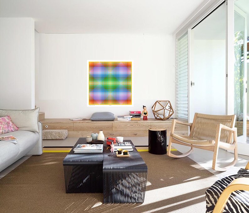 May include: A living room with a light brown rug, a gray couch, a black coffee table, a rocking chair, and a colorful abstract painting on the wall.