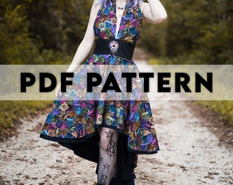 May include: PDF pattern for a high-low dress with a black halter top and a colorful, patterned skirt. The skirt features a variety of symbols and designs, including stars, circles, and other geometric shapes. The dress is shown on a model with purple hair and a black headband.
