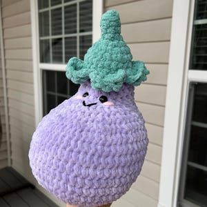 May include: A white ceramic mug with a black handle and the text "But First, Coffee" in a black, bold font. The mug is sitting on a wooden surface. The mug is approximately 4 inches tall.