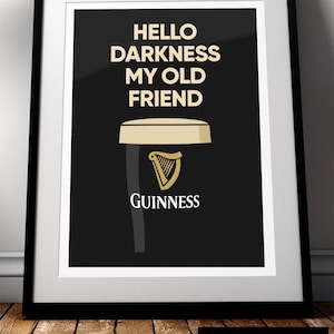 May include: Framed print with the text "HELLO DARKNESS MY OLD FRIEND" above a stylized Guinness pint. The print features a black background with a white border and a black frame. The Guinness logo is visible.