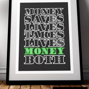 May include: Black and white typography print with the text "Money Saves Lives, Money Takes Lives, Money Both" with the word "Money" in green.