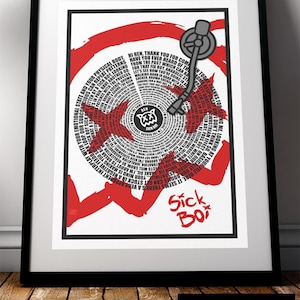 May include: Framed art print with a red and white vinyl record design. The artwork includes text, a record player arm, and the words "Sick Boy." The print is framed in a black frame, suitable for a wall.