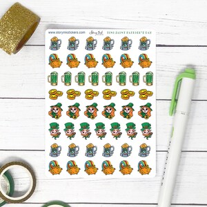 May include: A sheet of stickers featuring a variety of St. Patrick's Day themed designs. The stickers include leprechauns, pots of gold, beer mugs, and shamrocks. The sheet is white with a green border and the text "Fine Faine Patrick's Day" at the top.