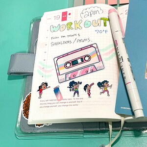 workout stickers applied on a Hobonichi planner A6 page. Fitness stickers with different poses used on a health/fitness journal and a cassette tape sticker with bright pinks, teals, yellow colors