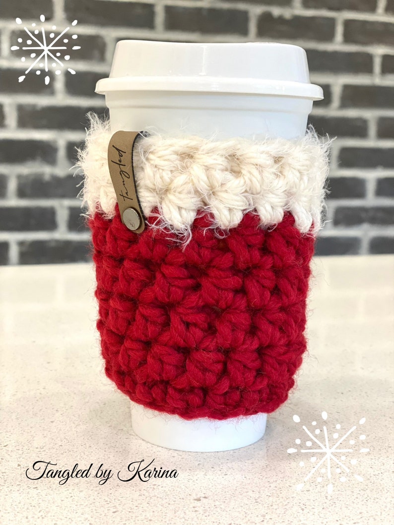 May include: Red and white crocheted coffee cup cozy with a brown leather tag that says "Tangled".