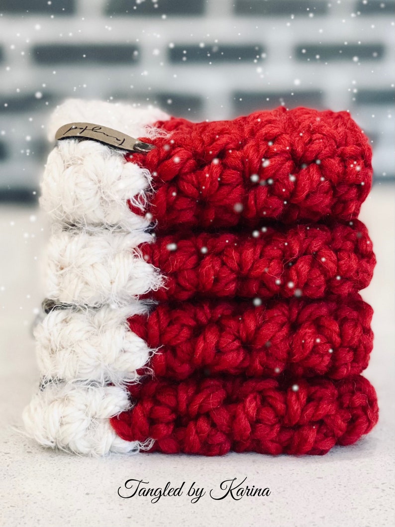 May include: A stack of five red and white crocheted Christmas stocking ornaments with a brown leather tag that says "Family".