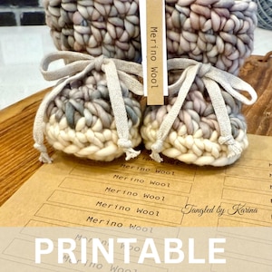 May include: Two small, hand-knitted Merino wool pouches with drawstring closures, in shades of cream, gray, and lavender. A larger basket is in the background. The word "PRINTABLE" is at the bottom of the image.