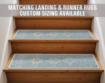 May include: A set of blue patterned stair treads with a white border. The treads are on a wooden staircase. The text "Matching Landing & Runner Rugs Custom Sizing Available" is at the top of the image.