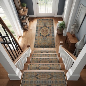 May include: A set of four stair treads with a blue, gold, and beige patterned design. The treads are placed on a wooden staircase with a white railing.