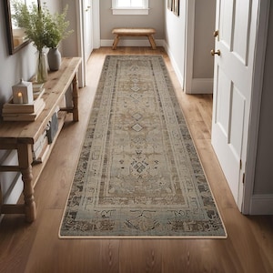 May include: A beige and brown patterned runner rug with a traditional design. The rug is laid out in a hallway with wooden floors and a wooden bench.