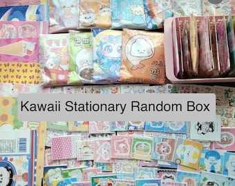 May include: A Kawaii Stationary Random Box filled with colorful stationery items, including stickers, paper, and envelopes. The box features a variety of cute characters and designs.