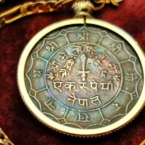 Fiery blue rainbow toned 1973 Nepali Trident of Shiva and sword of Kali Rupee Coin pendant on a gold filled chain. 28mm diameter real coin.
