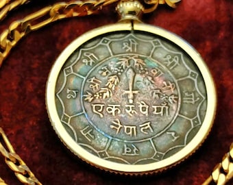 Fiery blue rainbow toned 1973 Nepali Trident of Shiva and sword of Kali Rupee Coin pendant on a gold filled chain. 28mm diameter real coin.
