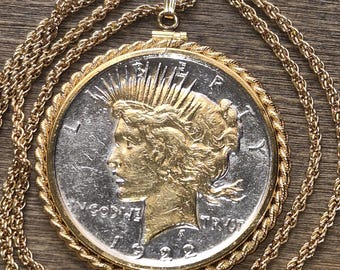 Gold Layered 1922 Brilliant Uncirculated Genuine American Peace .900 Silver Dollar Pendant set on an 18KGF Gold Plated Rope Chain.
