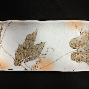 May include: A rustic wooden sign with the text "Welcome to our home" in white lettering. The sign features a distressed finish and a simple, inviting design, perfect for a front porch or entryway.