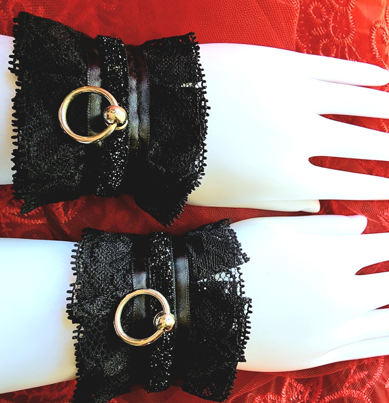Black lace and satin bondage cuffs with silver O-ring, stylish BDSM restraints for bondage wear and sex play.
