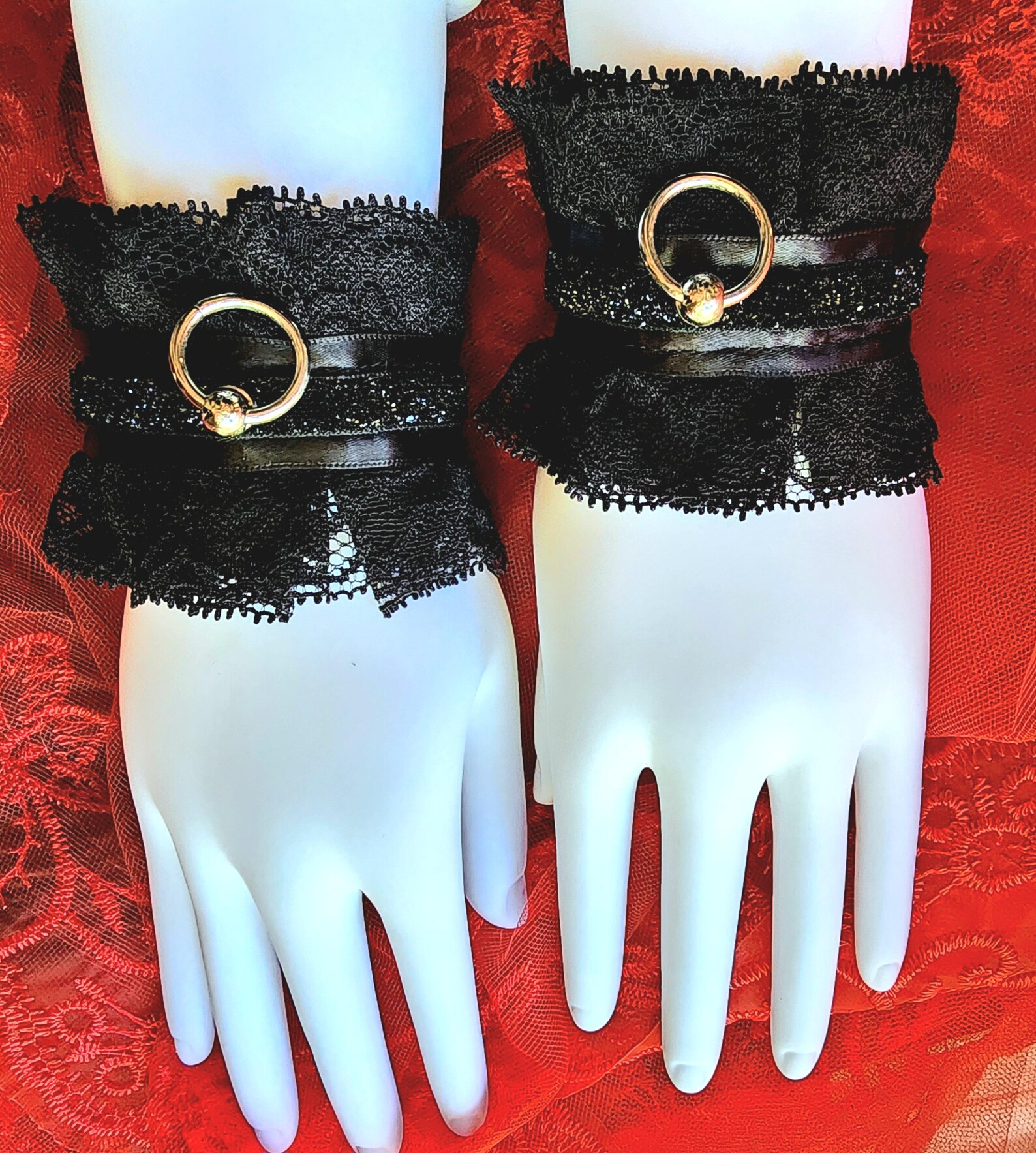 Black lace Victorian wrist cuffs with satin ribbon and silver O-ring, elegant bondage restraints for tie-up sex.