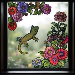 May include: A framed window art piece depicting a green gecko and vibrant flowers. The floral arrangement includes red, pink, purple, and yellow blooms with green foliage. The gecko is centrally placed within the window.