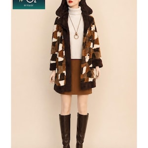 May include: A hooded coat featuring a patchwork pattern of brown, tan, and white faux fur, worn over a white turtleneck sweater and a brown skirt. The ensemble includes dark brown knee-high boots and a long gold-tone pendant necklace.